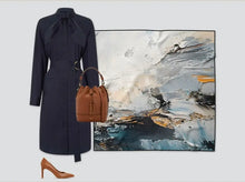 Load image into Gallery viewer, Navy coat, brown handbag, and high heels with an abstract painting in the background